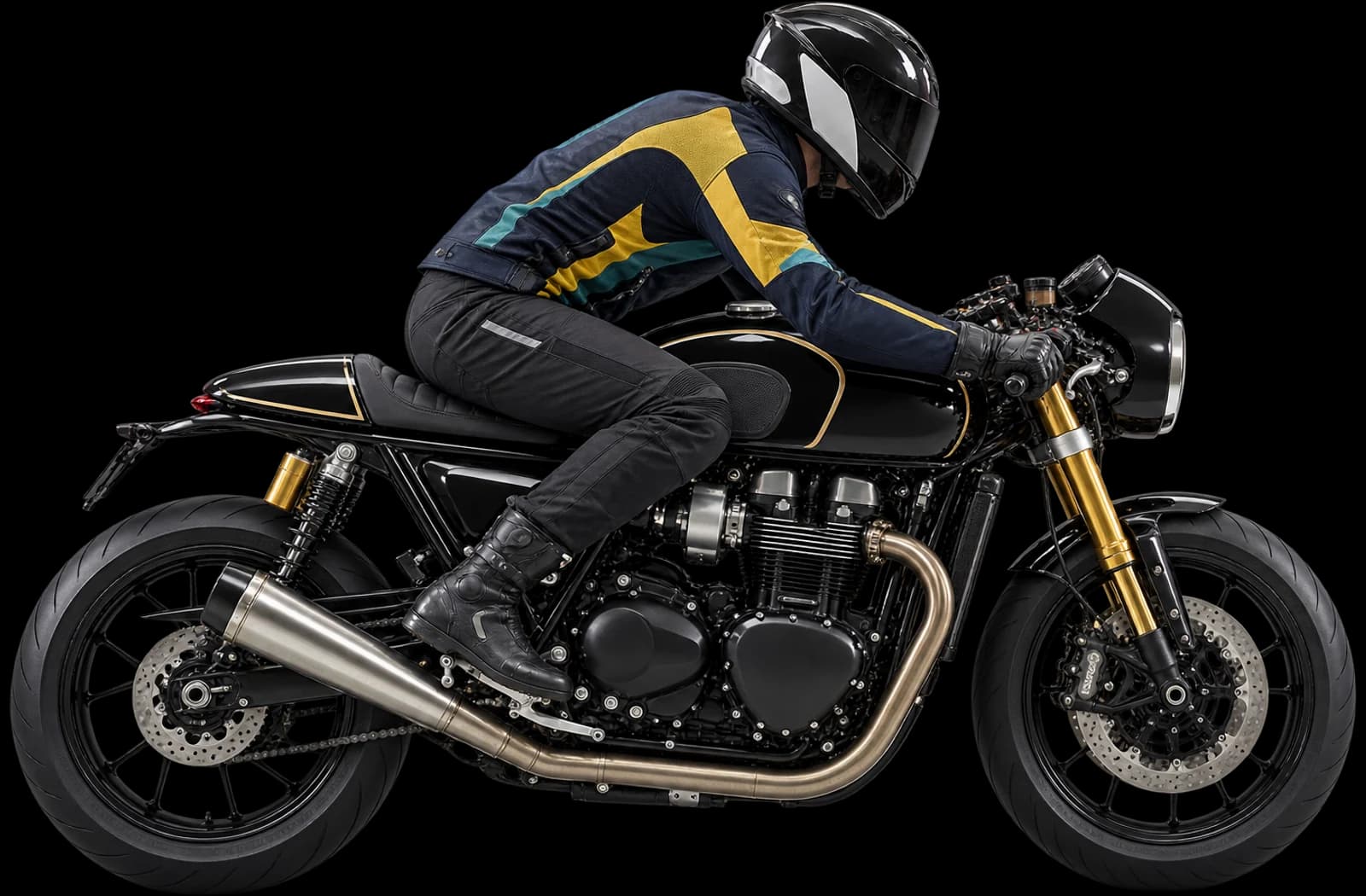 Motorcyclist in a navy, yellow and teal riding jacket leaning forward on a black cafe-racer motorcycle
